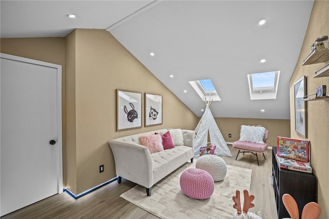 living area featuring wood finished floors, baseboards, recessed lighting, and vaulted ceiling with skylight