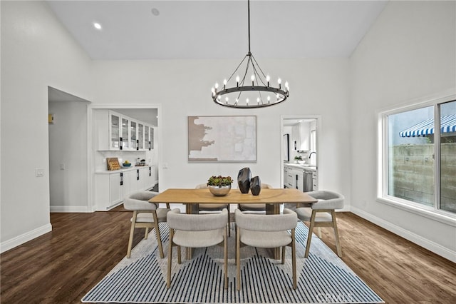 dining area featuring recessed lighting, a notable chandelier, dark wood-style floors, and baseboards