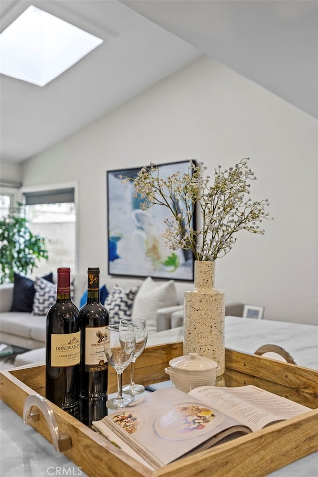 dining area with lofted ceiling with skylight