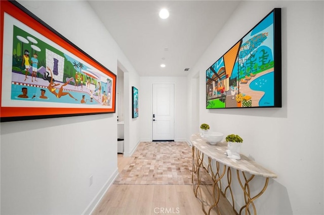 corridor featuring recessed lighting, baseboards, and wood finished floors