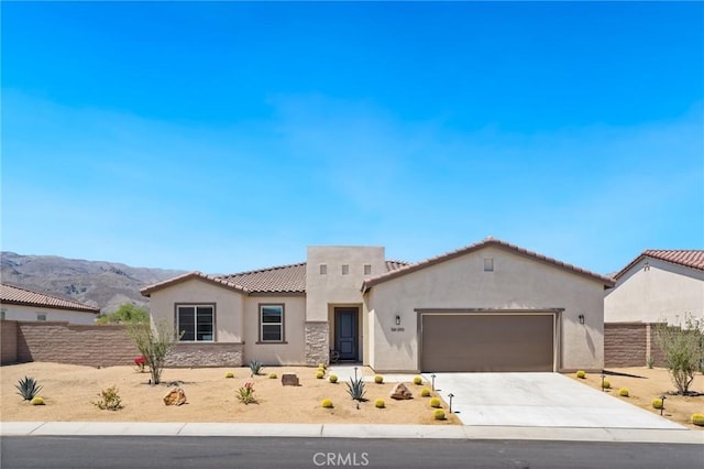 single story home featuring a garage, fence, driveway, and stucco siding