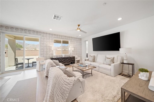 living area featuring visible vents, a ceiling fan, wood finished floors, and recessed lighting