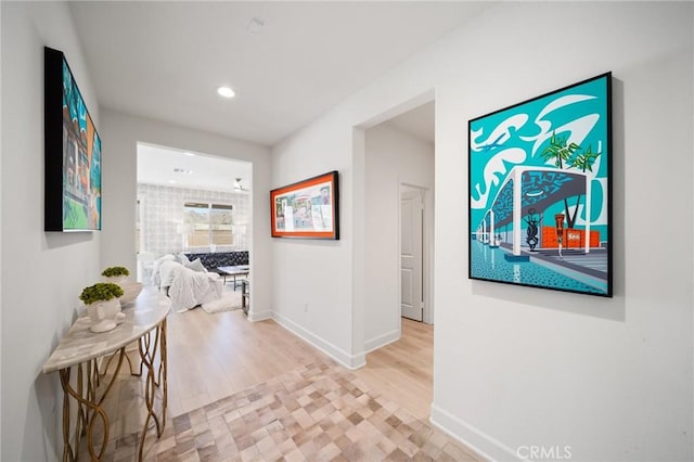 hall featuring recessed lighting, baseboards, and wood finished floors
