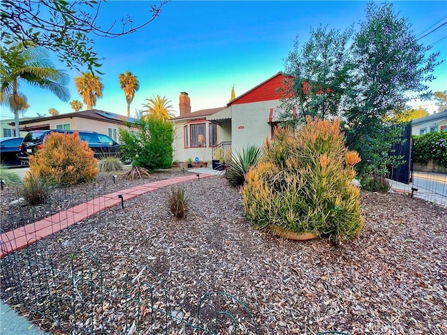 3704 Hellman Ave, Los Angeles, CA 90032 - view of front of home featuring a chimney, stucco siding, and fence