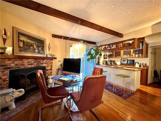 3704 Hellman Ave, Los Angeles, CA 90032 - dining room featuring a textured ceiling, wood finished floors, a brick fireplace, beamed ceiling, and a chandelier