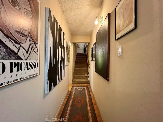 3704 Hellman Ave, Los Angeles, CA 90032 - hall featuring a textured ceiling, stairs, and baseboards