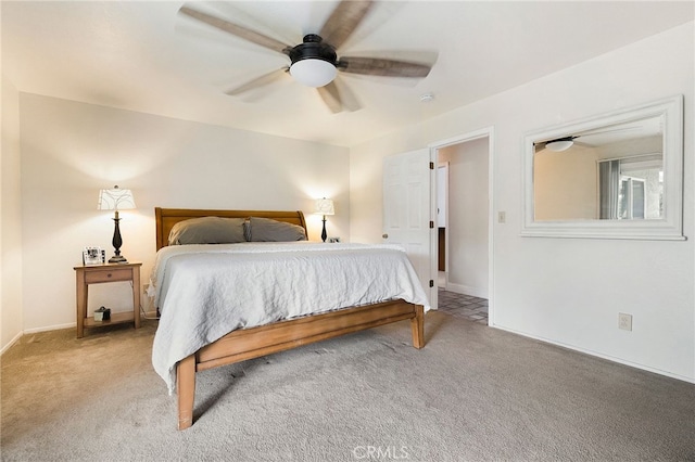 carpeted bedroom with a ceiling fan and baseboards