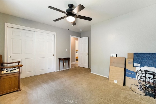 interior space with ceiling fan, carpet flooring, and baseboards