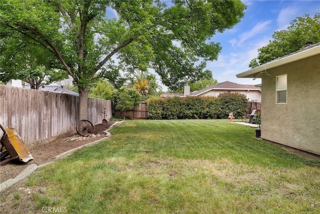 view of yard with a fenced backyard