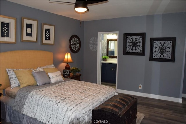 bedroom with wood finished floors, ensuite bathroom, and baseboards