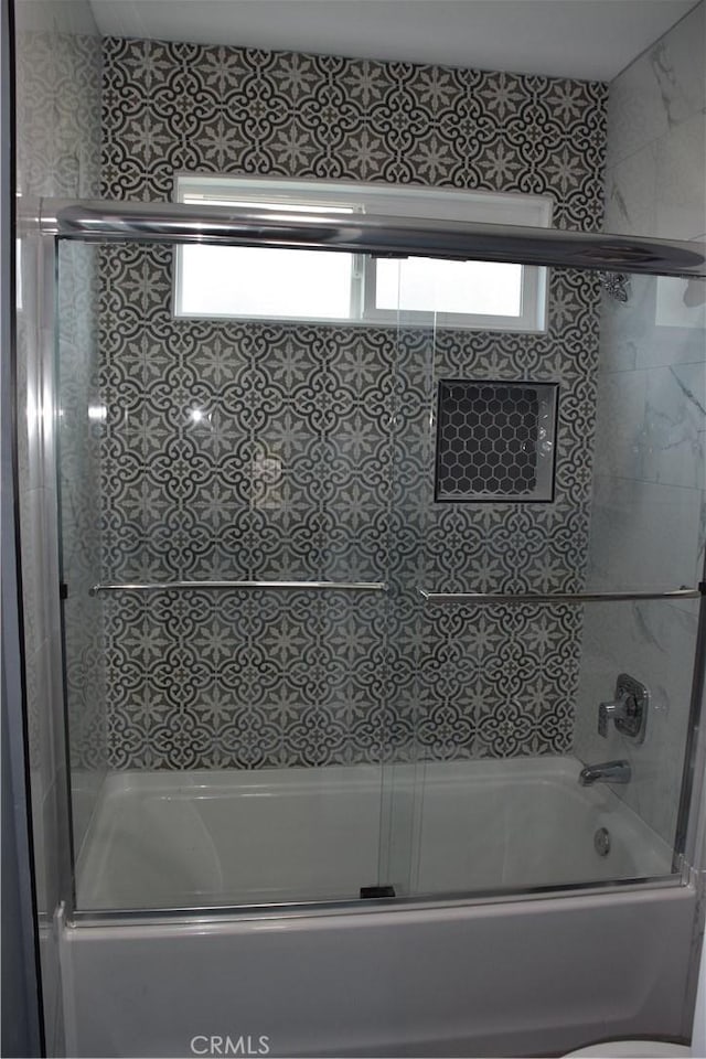 full bath featuring shower / bath combination with glass door