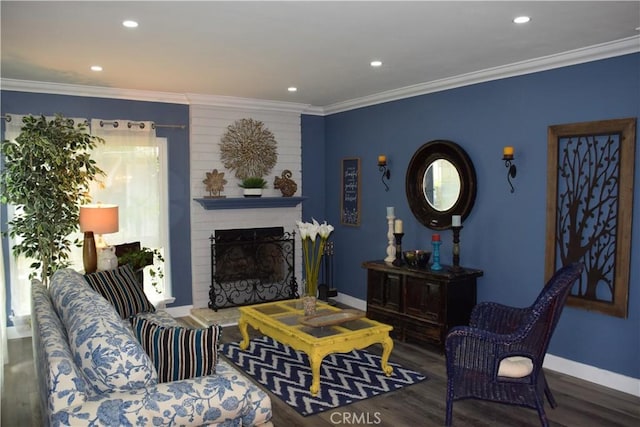 living room featuring a brick fireplace, wood finished floors, crown molding, and baseboards