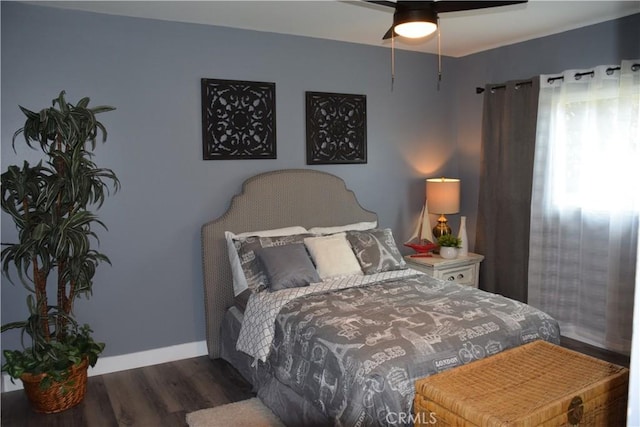 bedroom with dark wood finished floors, baseboards, and ceiling fan