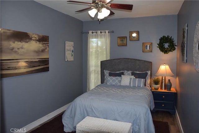 bedroom with wood finished floors, a ceiling fan, and baseboards