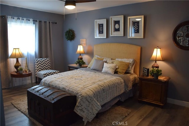 bedroom with baseboards and wood finished floors