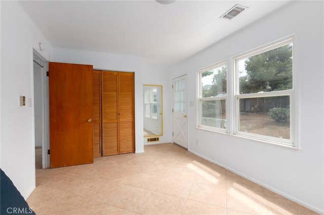 20095 Gustin Rd, Perris, CA 92570 - unfurnished bedroom with light tile patterned floors, baseboards, a closet, and visible vents