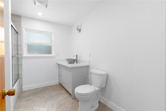 20095 Gustin Rd, Perris, CA 92570 - bathroom featuring toilet, baseboards, enclosed tub / shower combo, and vanity