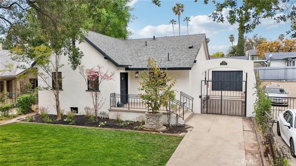 1309 N Chester Ave, Pasadena, CA 91104 - tudor home featuring stucco siding, a gate, fence, roof with shingles, and a front yard