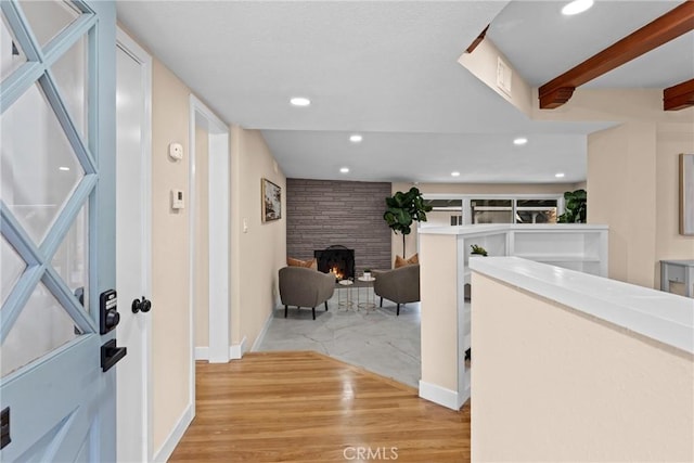 hallway featuring light wood-style floors, recessed lighting, visible vents, and baseboards