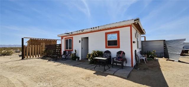 back of house with a patio and fence