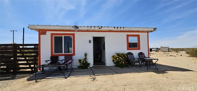 back of property featuring fence and a patio area