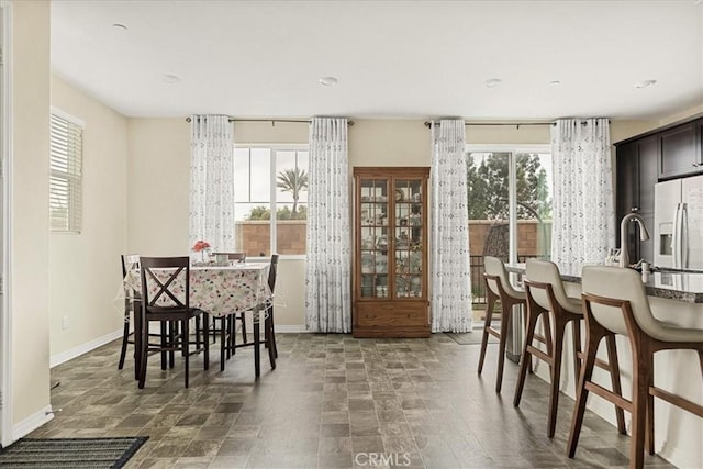 dining area featuring a healthy amount of sunlight and baseboards