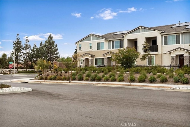 view of front of property with stucco siding and fence