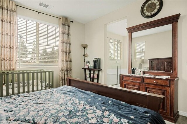 bedroom featuring visible vents and baseboards