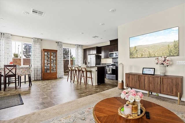living room with visible vents and plenty of natural light