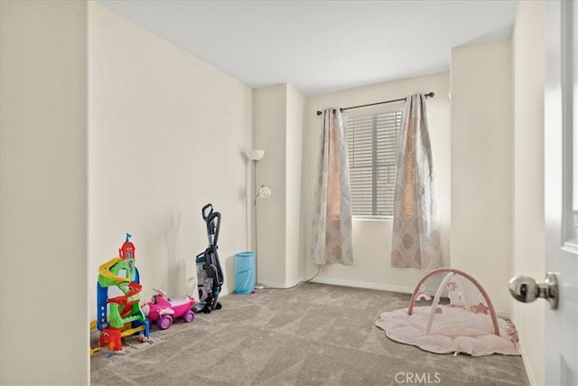 rec room with baseboards and carpet floors