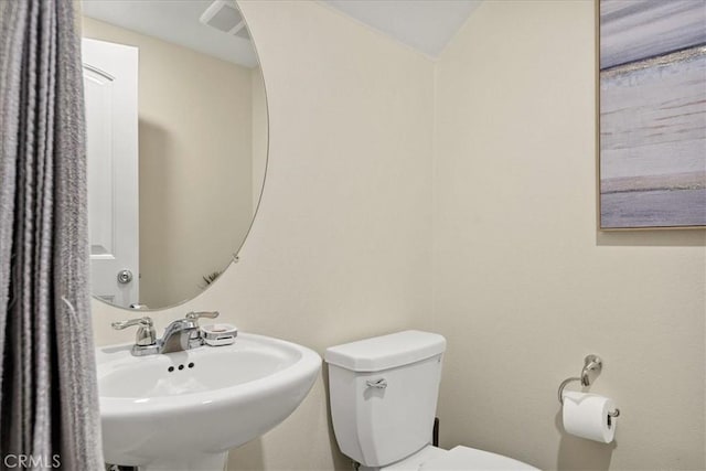 bathroom with toilet and a sink
