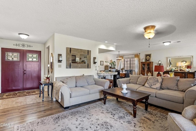 living area featuring a textured ceiling and wood finished floors