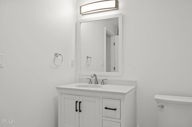 half bathroom with toilet and vanity