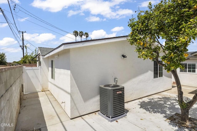 view of home's exterior with central AC unit and stucco siding