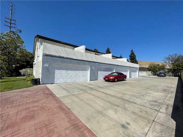13252 Newland St A-D, Unit A-D Garden Grove, CA 92844 - view of side of home with stucco siding and community garages