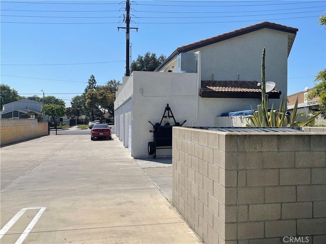 13252 Newland St A-D, Unit A-D Garden Grove, CA 92844 - view of side of property featuring stucco siding and a tiled roof