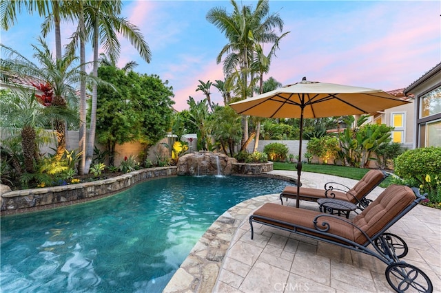 view of swimming pool featuring a fenced in pool, a fenced backyard, and a patio area