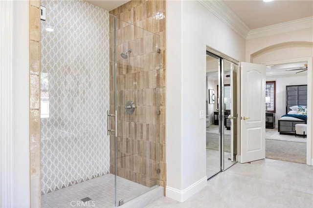 ensuite bathroom featuring baseboards, ornamental molding, a shower stall, and ensuite bath