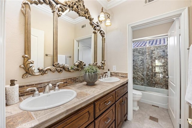 bathroom featuring toilet, visible vents, ornamental molding, and a sink