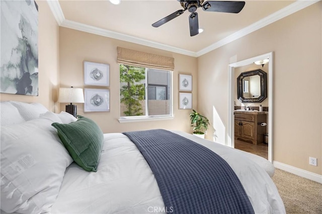 bedroom featuring crown molding, carpet floors, baseboards, ceiling fan, and a sink