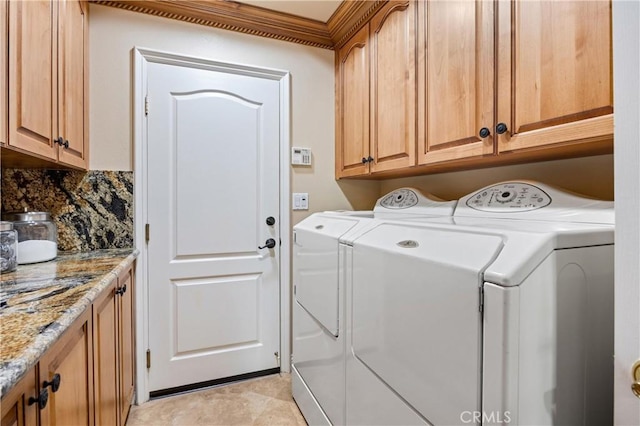washroom featuring washing machine and clothes dryer and cabinet space