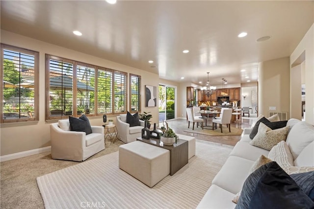 living area featuring recessed lighting, baseboards, a notable chandelier, and visible vents