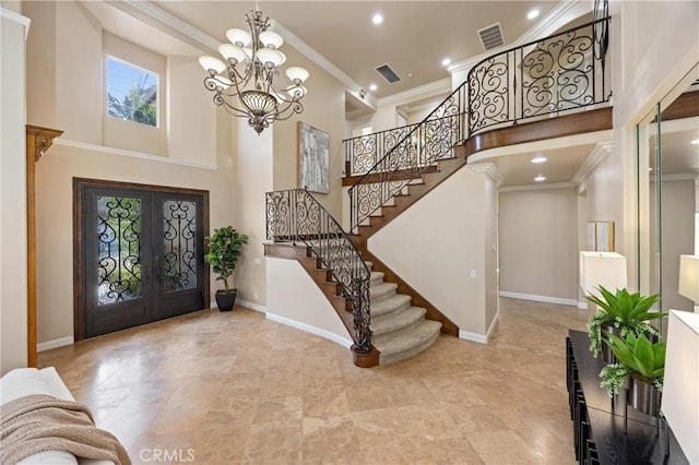 entrance foyer with a high ceiling, a chandelier, french doors, and stairway