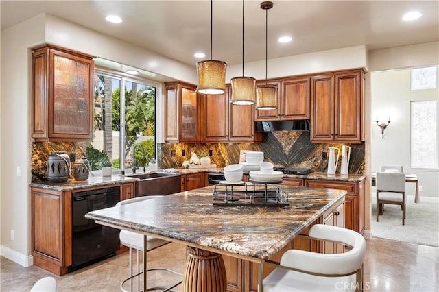 kitchen featuring a breakfast bar, brown cabinetry, and dishwasher