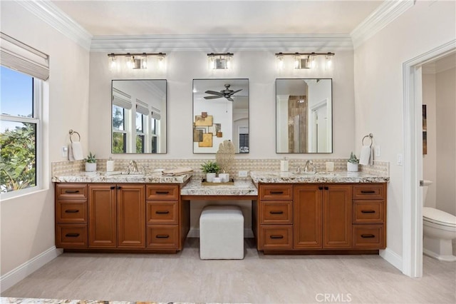 full bath featuring vanity, ornamental molding, a ceiling fan, and toilet
