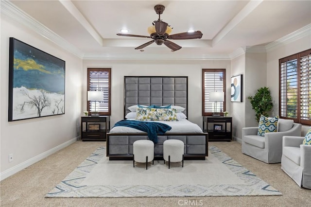 carpeted bedroom featuring crown molding, a raised ceiling, and baseboards