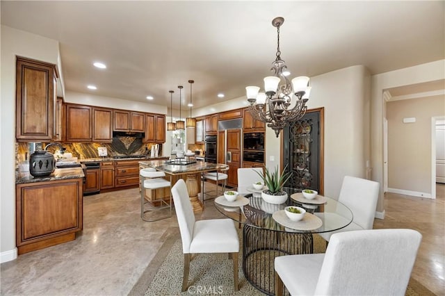 dining room featuring baseboards, recessed lighting, and a chandelier