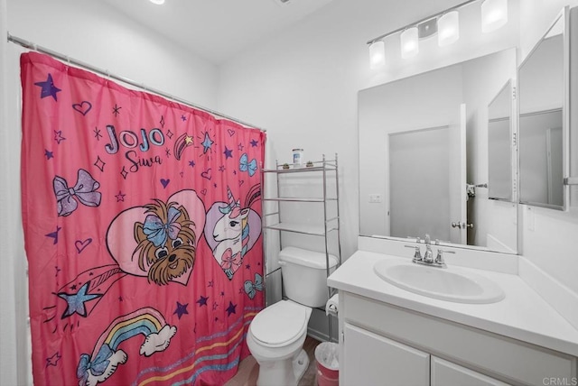 bathroom with vanity, toilet, and a shower with shower curtain