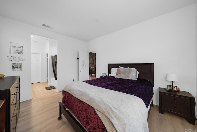 bedroom with visible vents and light wood finished floors