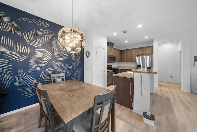 dining room with recessed lighting, light wood-style flooring, a chandelier, and baseboards